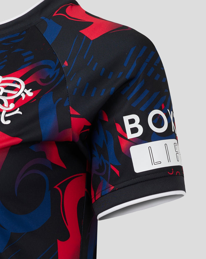 Close up of the Rangers Third Shirt shoulder showing bold red and blue abstract print.