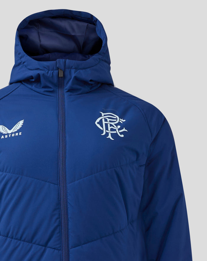 Blue bench jacket chest area with Castore wing logo on the left and a crest on the right