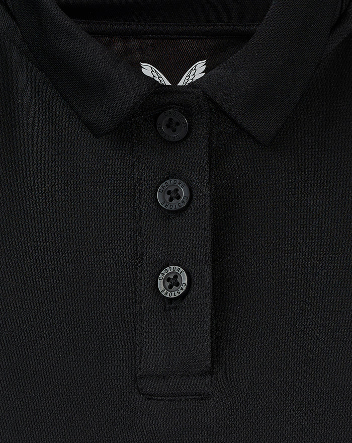 Close-up of black women's coaches presentation polo collar with three buttons and Castore branding and white wing crest.