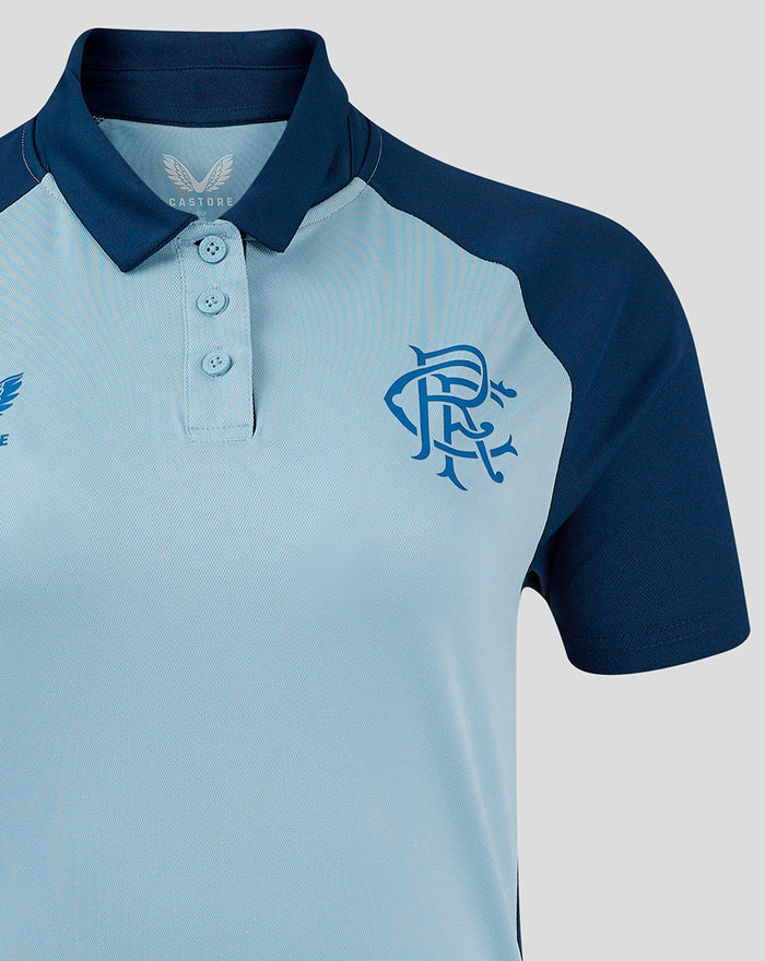 Close-up of women's Rangers Pro Players Presentation Polo showing light blue body with navy collar and sleeves three-button placket and left chest crest with right chest Castore branding