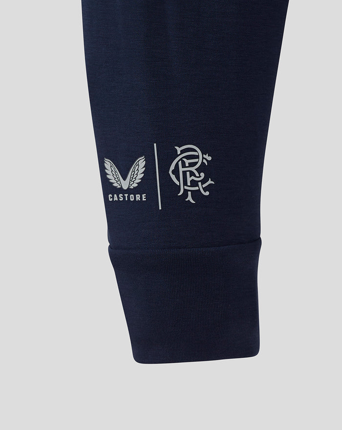 Close-up of navy sleeve showing Castore logo and Rangers club crest near the cuff.
