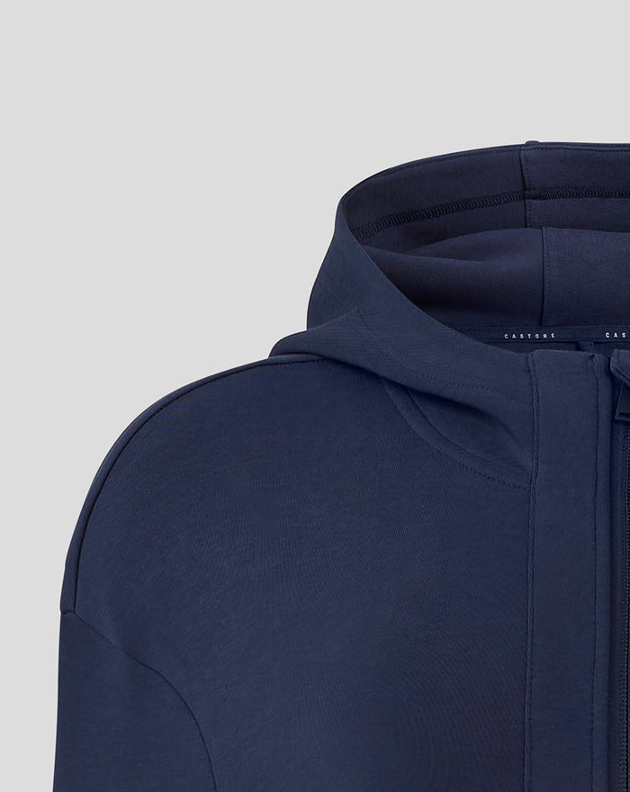Close-up of navy hooded travel jacket collar with zipper pull and Castore branding