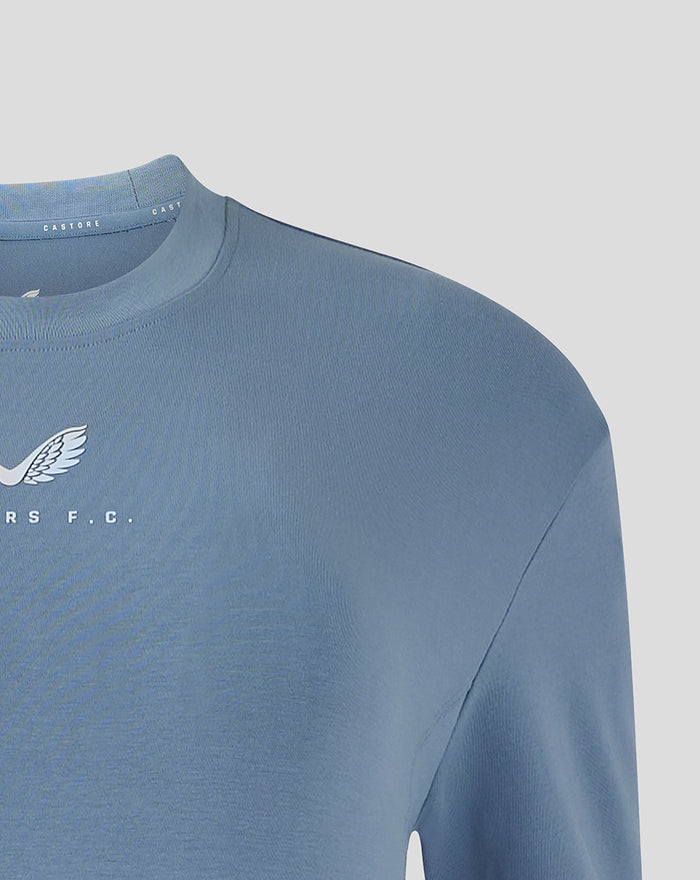 Close up of blue travel T shirt neckline showing Castore branding along the collar.