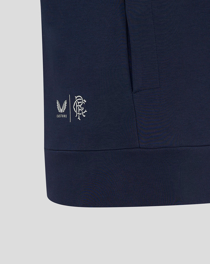 Navy travel hoodie hem with Castore and club crests visible near the left side seam