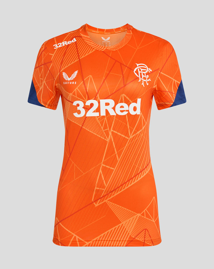 Orange women's league matchday T-shirt with geometric pattern, white 32Red sponsor, chest crest, and blue sleeve cuffs.