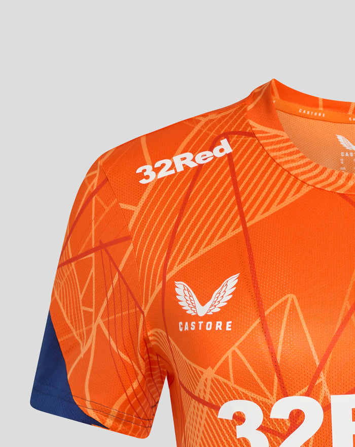 Close up of bright orange women's league matchday T shirt with white 32 numbers and geometric pattern
