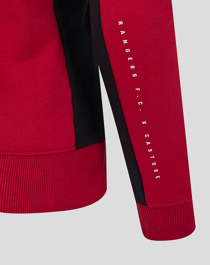 Red sleeve with black side stripe and vertical Rangers FC X Castore text along the forearm.