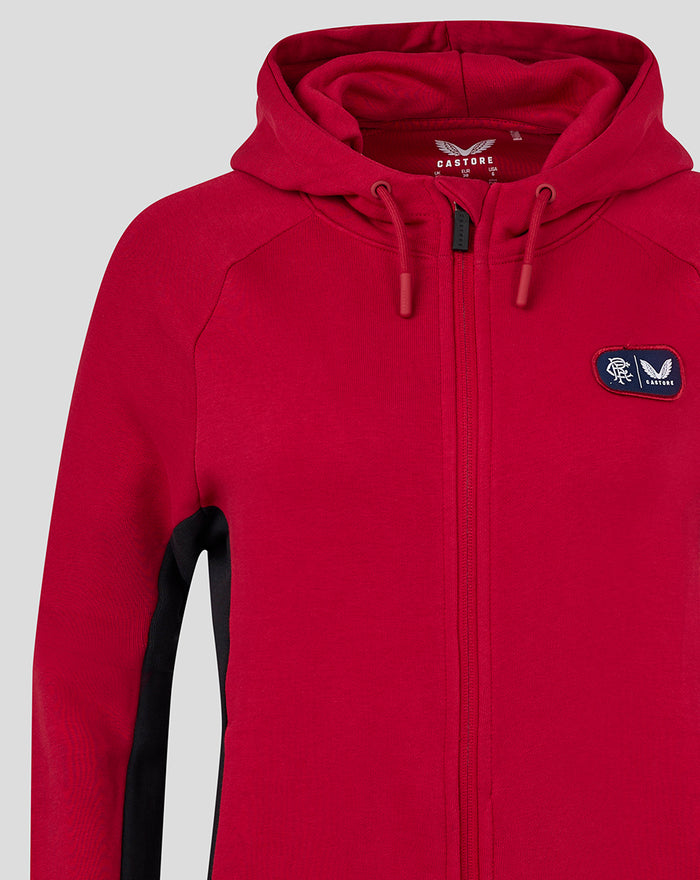 Close up of left chest on red fleece jacket showing a navy patch with Rangers crest and Castore badge.