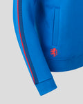 Blue hoodie sleeve close up with two tone stripe and ribbed cuff and pocket edge and red crest