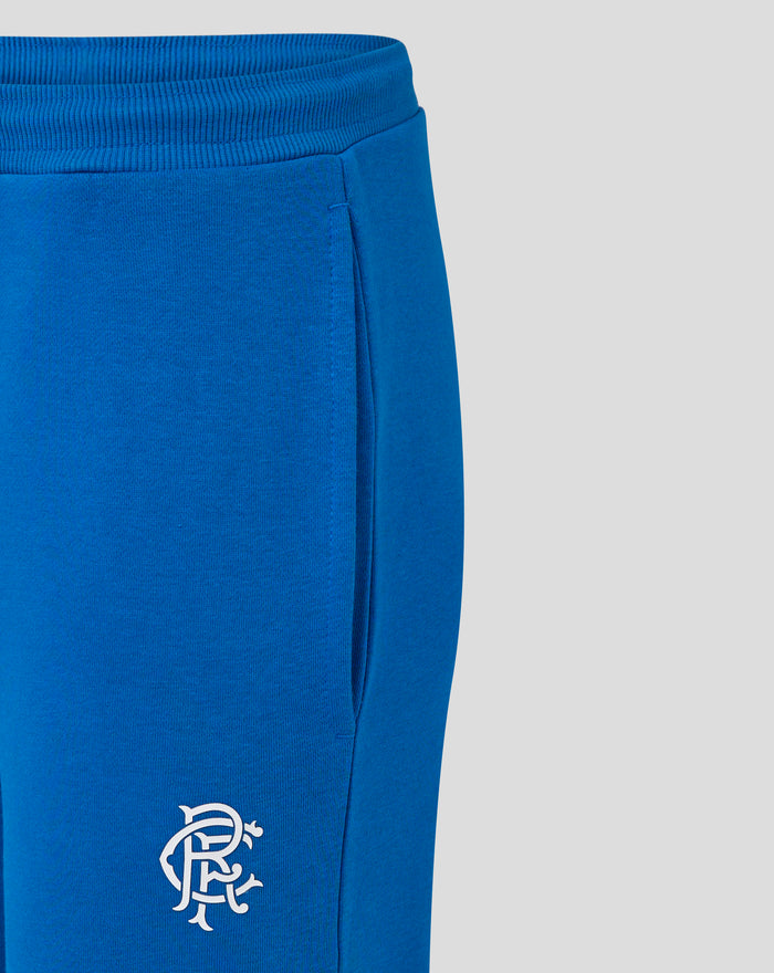 Close up of blue Women's Rangers FC Core Joggers highlighting elastic waistband ribbed cuffs and a partial crest at the thigh.