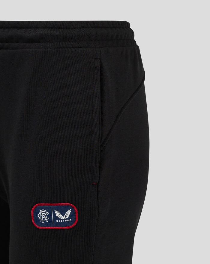 Close up of black joggers waistband with external drawcord and left thigh badge patch.