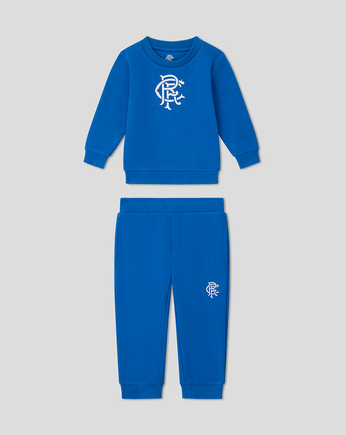 Front view of blue infant core sweatshirt set with white crest on chest and matching pants