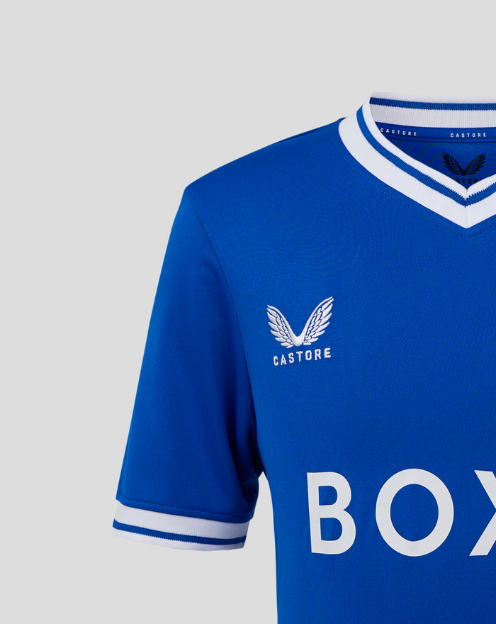 Close-up of blue Rangers heritage jersey shoulder with white trim crest and Castore branding.