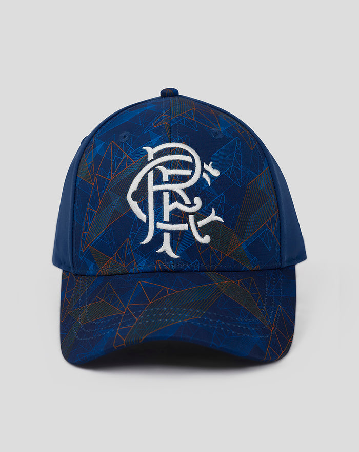 Front view of Club Matchday Cap Juniors in blue with a large white emblem on the front and an abstract geometric pattern.