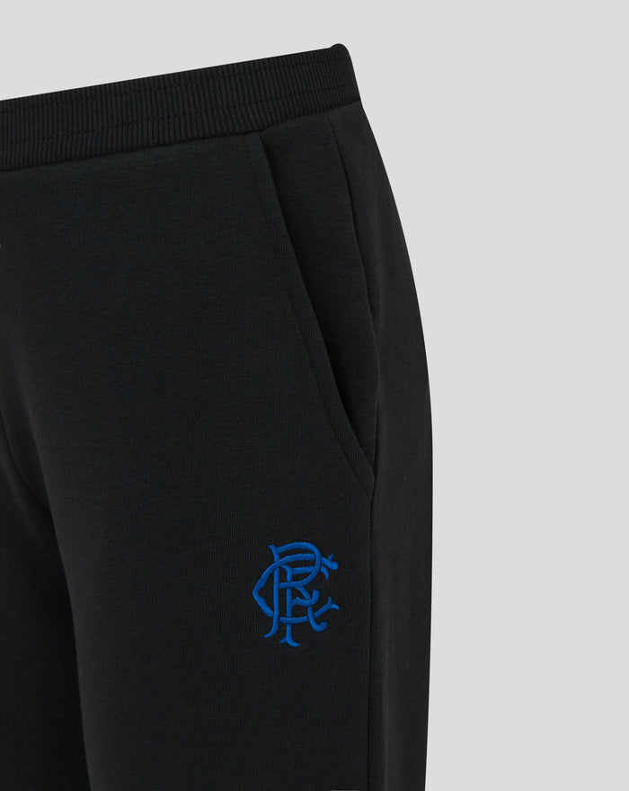 Close-up of a black JUNIOR CORE jogger showing elastic waistband and pocket with blue Rangers scroll crest embroidery