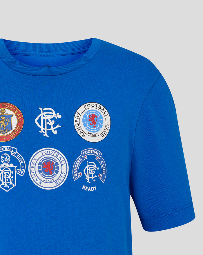 Rangers Junior 25/26 Badge T shirt in lapis blue with multiple circular club logos on the chest