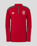 Red junior training top with grey shoulders and small brand logo on left, white crest on the right chest.