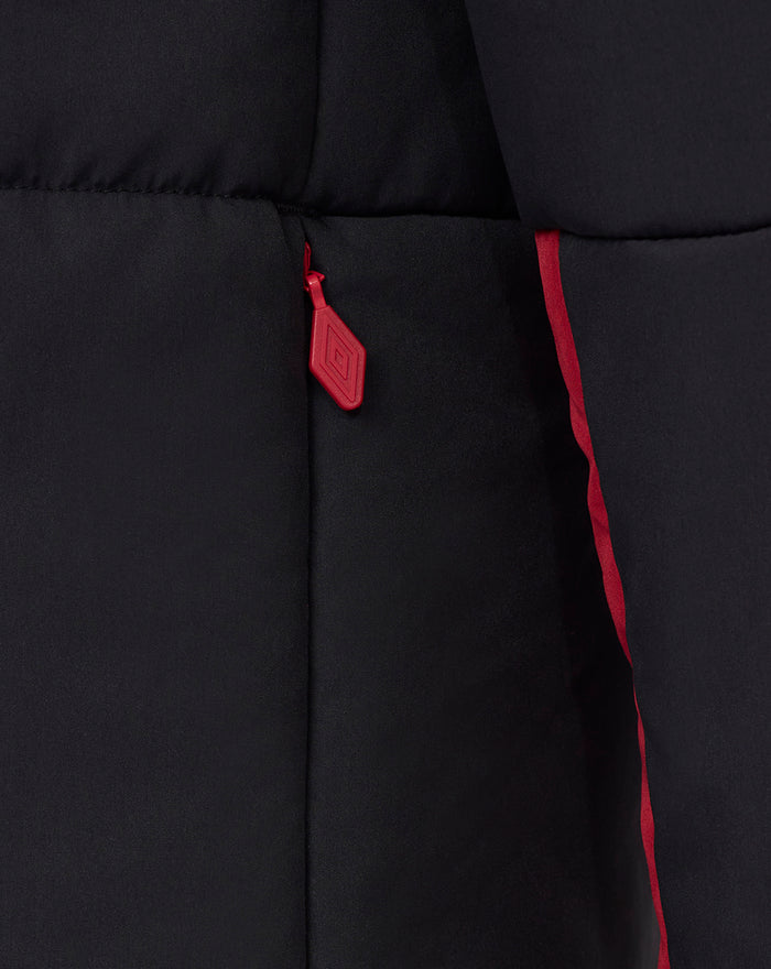Close-up of the red zipper pull and front seam on the black padded jacket.