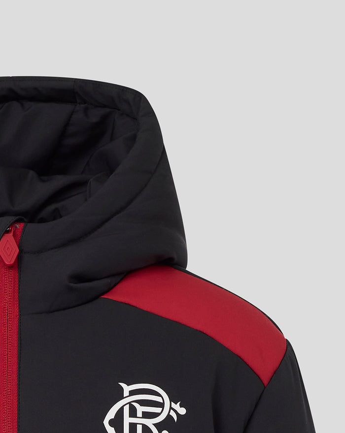 Close-up of hooded junior padded jacket with black fabric red shoulder panel and white crest on the chest.