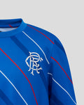 Close-up of blue junior Rangers FC home matchday tee featuring the club crest on the chest and diagonal stripe pattern