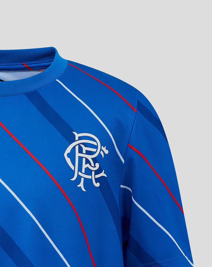 Close-up of blue junior Rangers FC home matchday tee featuring the club crest on the chest and diagonal stripe pattern