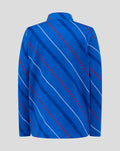 Back view of blue junior home matchday jacket with diagonal red and white stripes across the fabric.