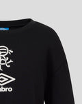 Close-up of black junior travel T shirt front with white club crest and Umbro logo.