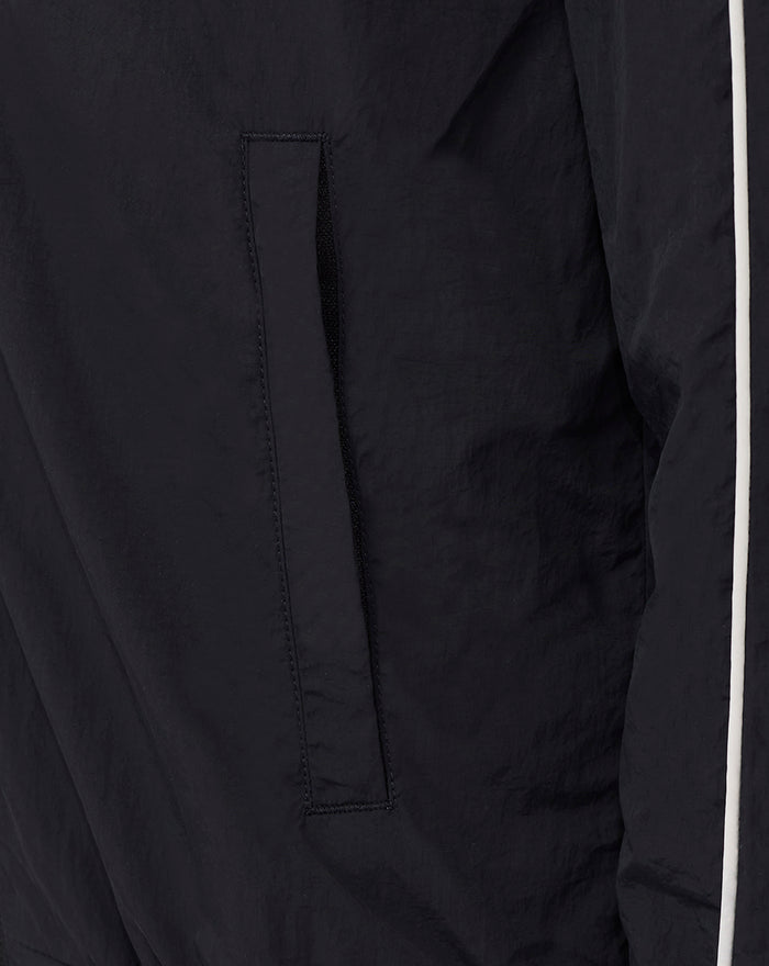 Close up of black travel track jacket pocket on the front panel