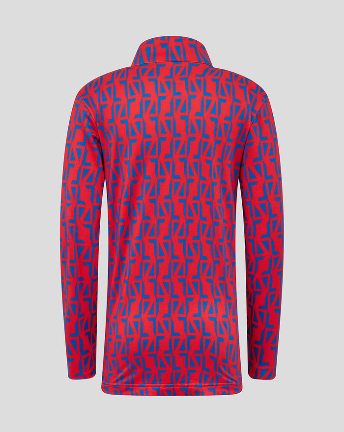 Back view of the junior red and blue geometric print jacket with a collar and a white Umbro logo on the lower back.
