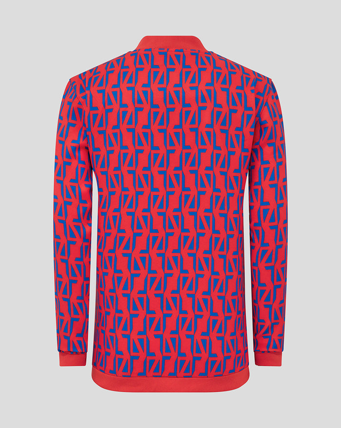 Back view of junior away matchday jacket in red and blue geometric print with ribbed cuffs and hem