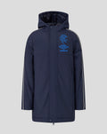 Front view of junior navy travel bench jacket with blue crest and Umbro logo on the chest and a hood
