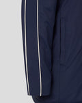Side profile of navy Junior 25/26 Travel Bench Jacket showing white piping along the sleeve and a vertical pocket
