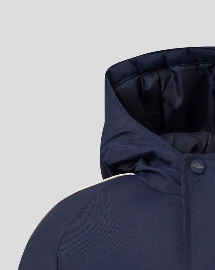 Close-up of navy Junior 25/26 Travel Bench Jacket hood and collar area with a small front snap