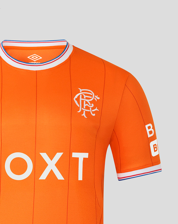 Close-up of upper chest on orange Rangers shirt showing crest Umbro logo and B sleeve patches