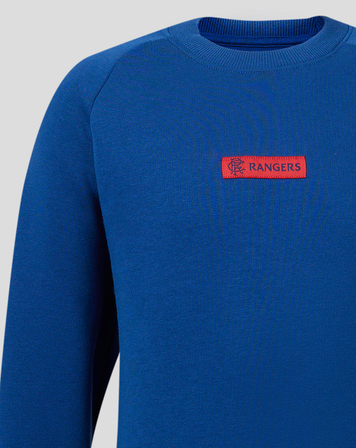 Blue junior Rangers crew sweatshirt close up of red silicon club crest on the left chest