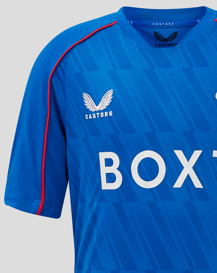 Front close-up of blue Rangers junior home shirt showing left chest crest and Castore branding on the right chest.