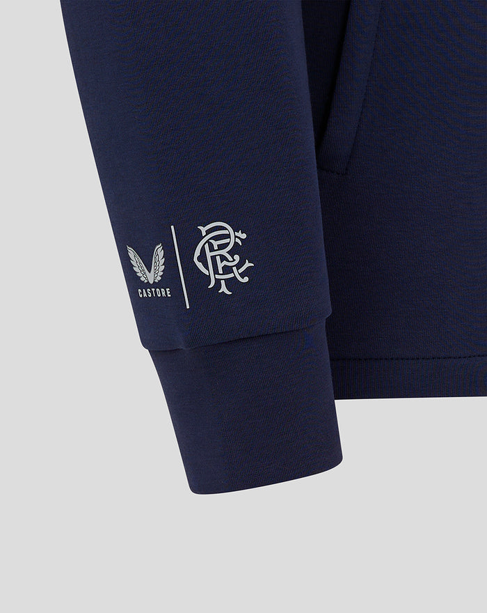 Close-up of navy Junior Rangers FC Hooded Travel Jacket sleeve with Castore and club logos near the cuff