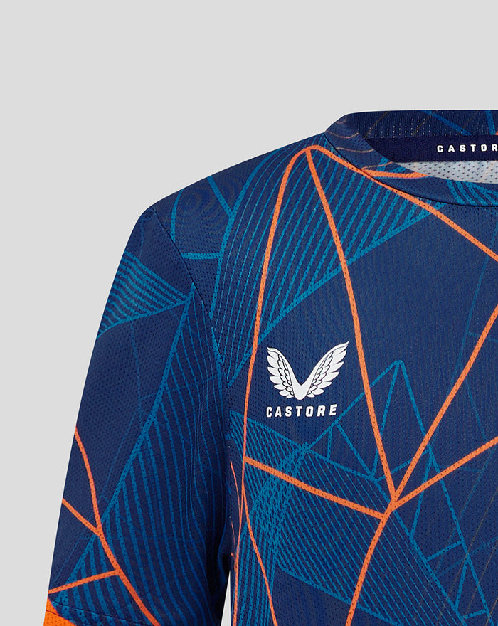 Detail of blue patterned jersey fabric with orange lines and visible mesh texture at the shoulder
