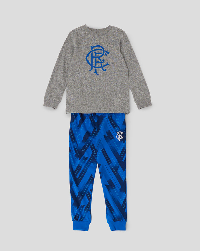 Junior long sleeve pyjamas top in grey heather with blue crest logo, paired with blue geometric print pants.