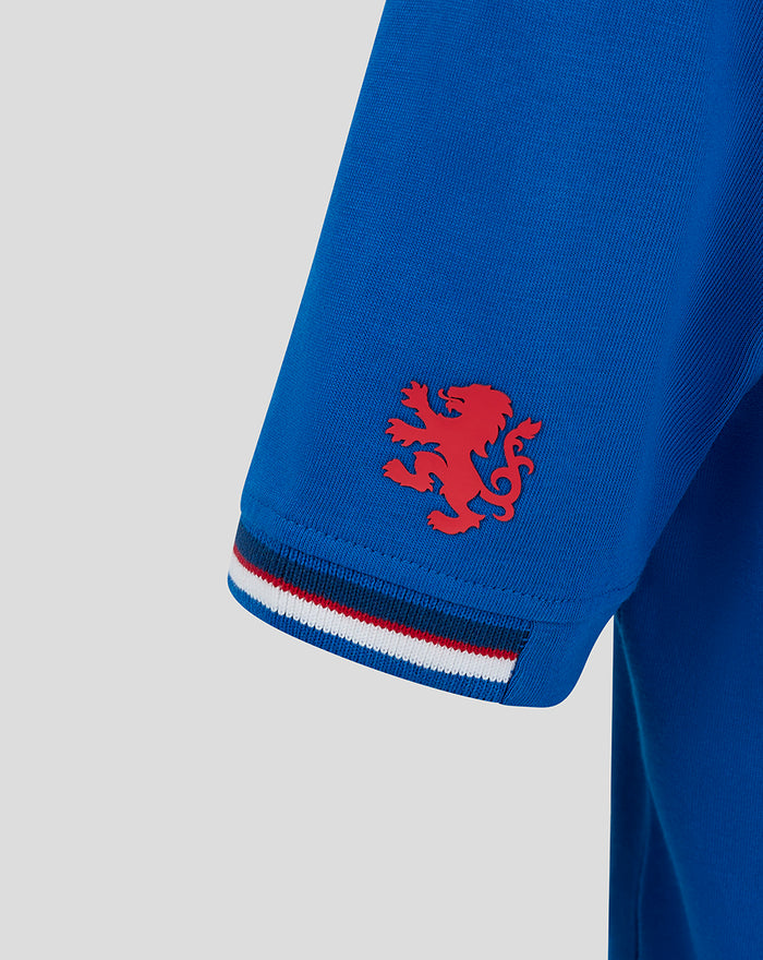 Sleeve hem detail with a red lion emblem and a striped cuff in red white and blue on the blue T shirt