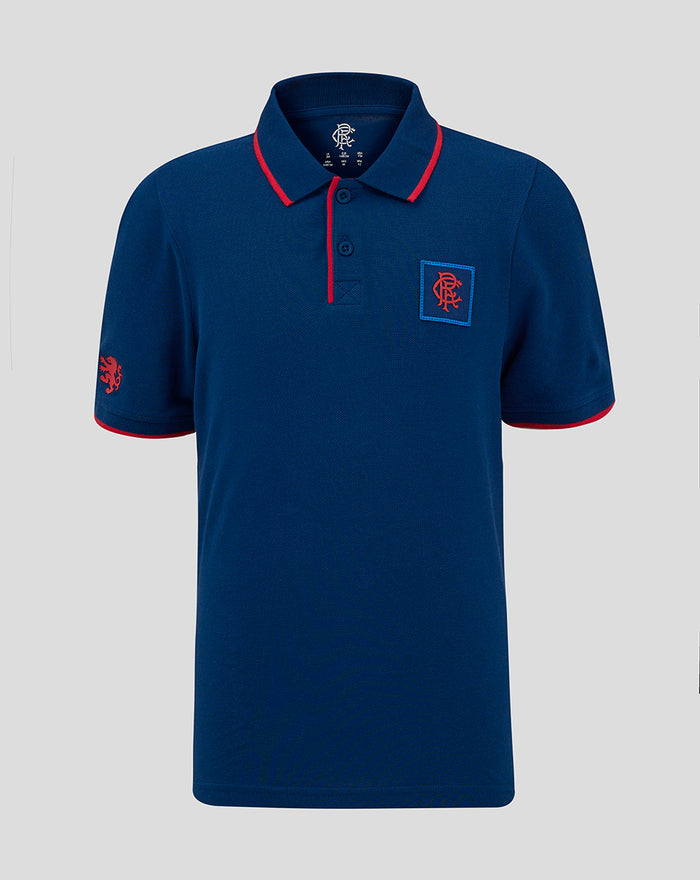 Junior classic polo in navy with red piping on collar and placket, chest crest patch and lion emblem on sleeve