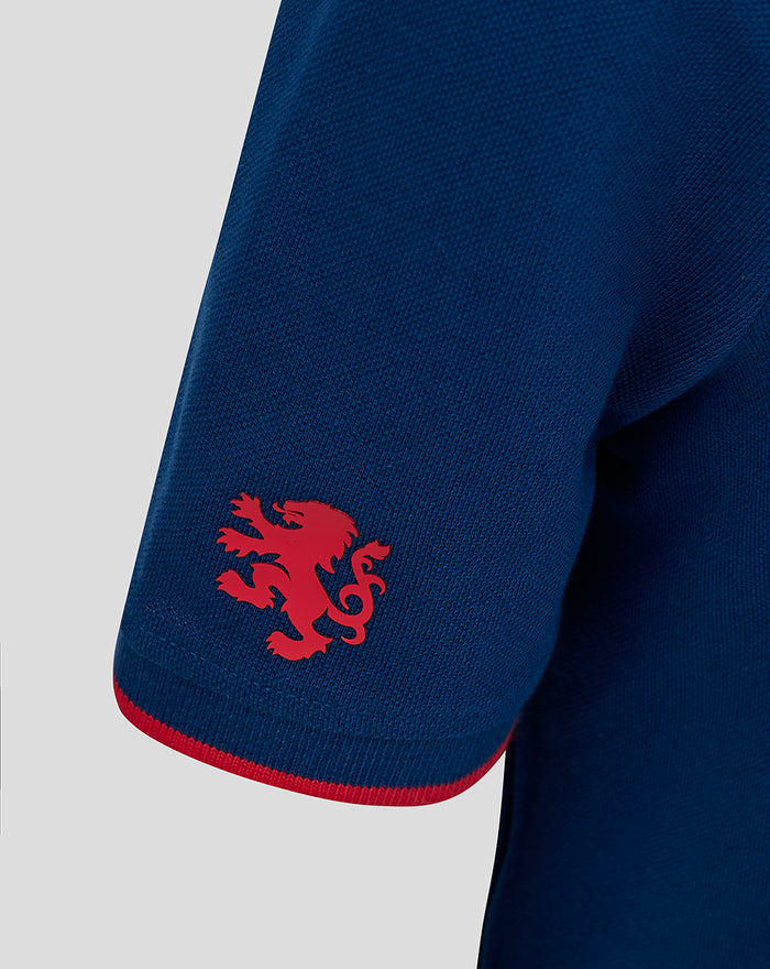 Close-up of navy Junior Classic Polo sleeve with red trim and crest emblem