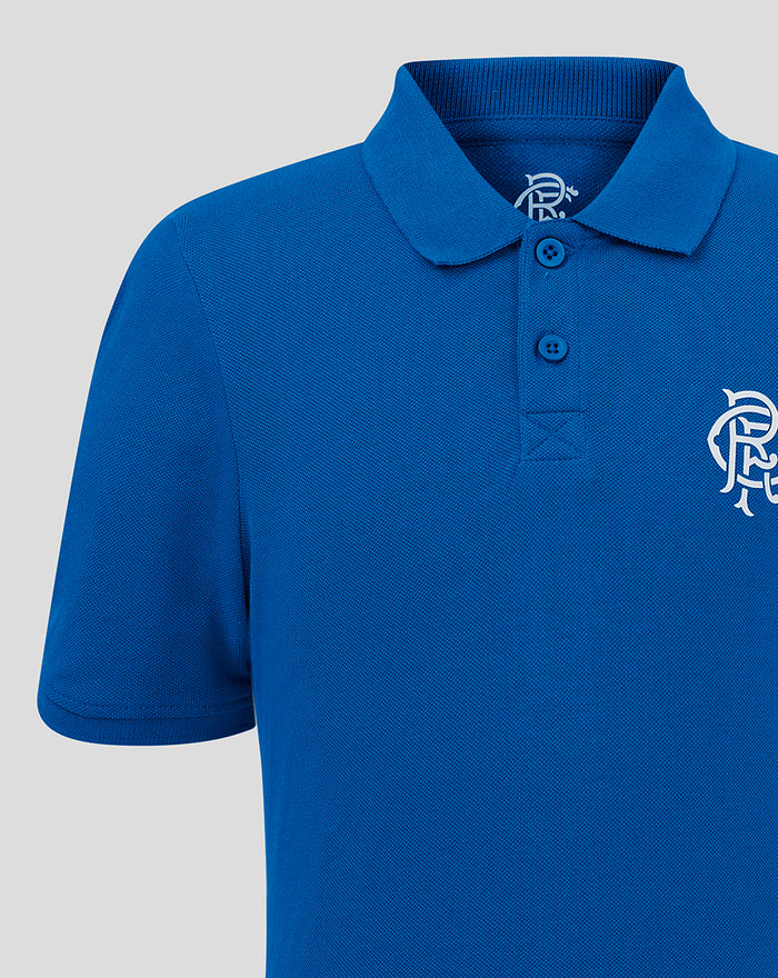 Close-up of blue polo shirt showing collar buttons and left chest crest