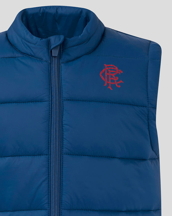 Close-up of navy Junior Core Fan Gilet showing the front zipper and red chest emblem.