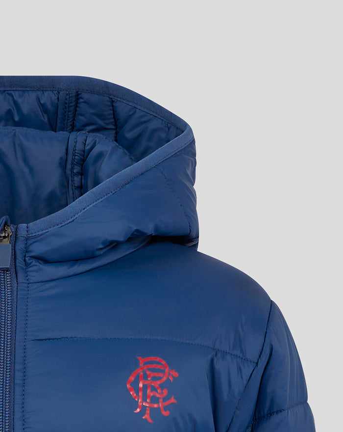 Navy JUNIOR 24/25 CORE FAN PUFFER JACKET chest view featuring a red crest logo and front zipper near the collar.