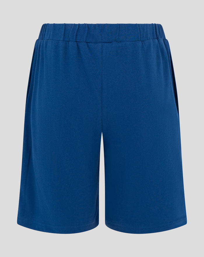 Front left leg of blue Rangers pajama shorts featuring a white crest