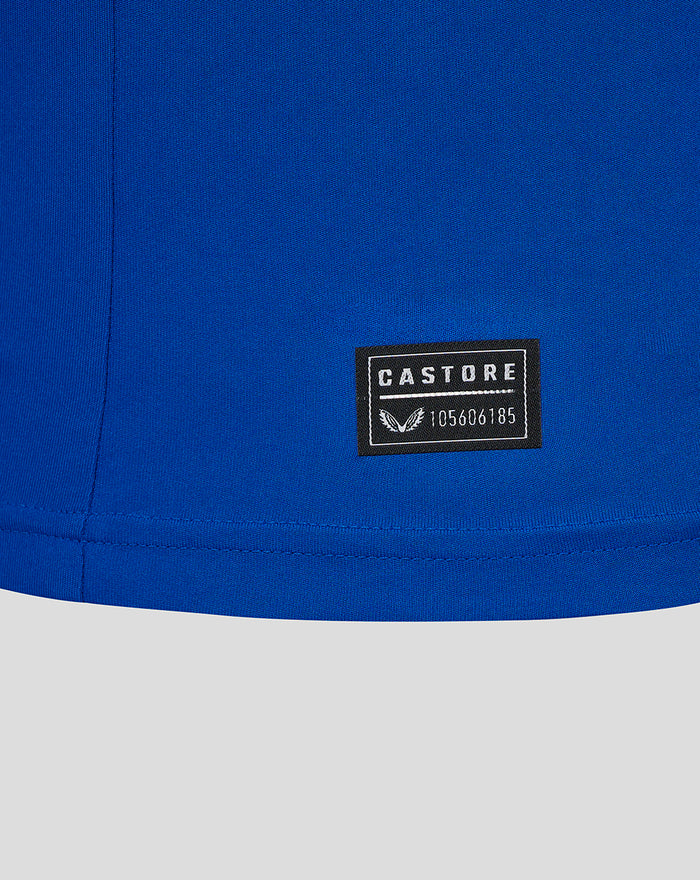 Close up of blue fabric with a Castore badge near the hem on the Ibrox 125 heritage shirt