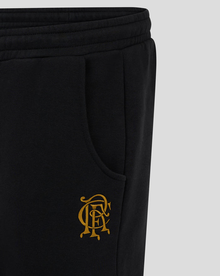 Close up of black jogger with gold Rangers crest embroidered near the pocket.