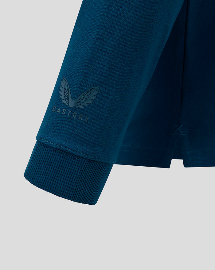 Close up of teal sleeve cuff on MENS IBROX 125 heritage polo with Castore logo and wing emblem.