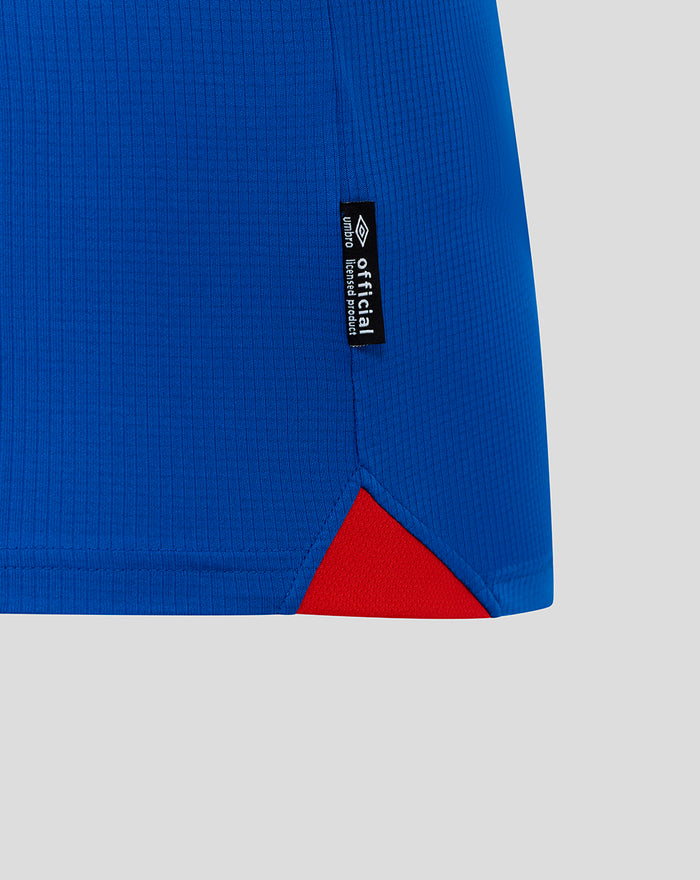 Close-up of blue Rangers FC home shirt hem with a red triangular insert and a small official product tag